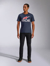 Alpinestars Ride 4.0 CSF Tee, Short Sleeve T-Shirt, Navy Blue with red Alpinestars star logo and white 'RIDE' text on the chest, worn by model with black pants and black sneakers, casual motorsport-inspired streetwear