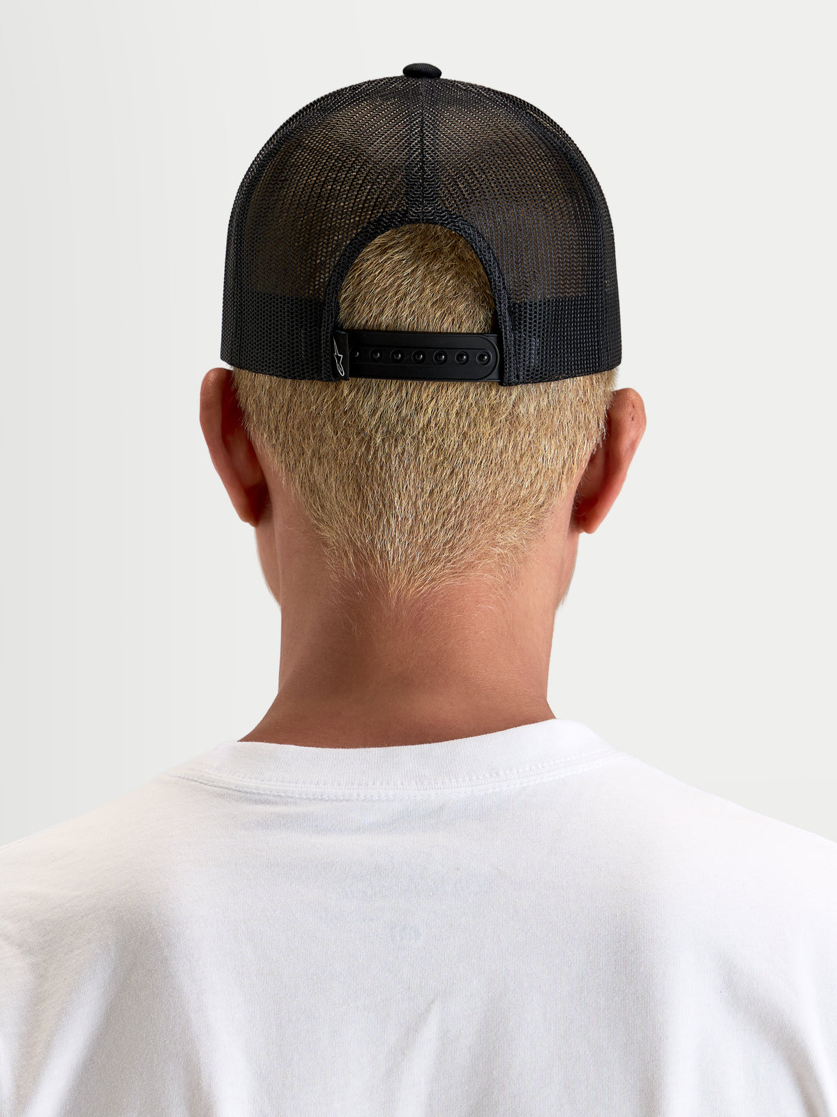 Alpinestars Gorra Heritage Patch, gorra trucker casual de malla, negra, vista trasera que muestra el cierre snapback ajustable y la construcción de malla de poliéster en modelo