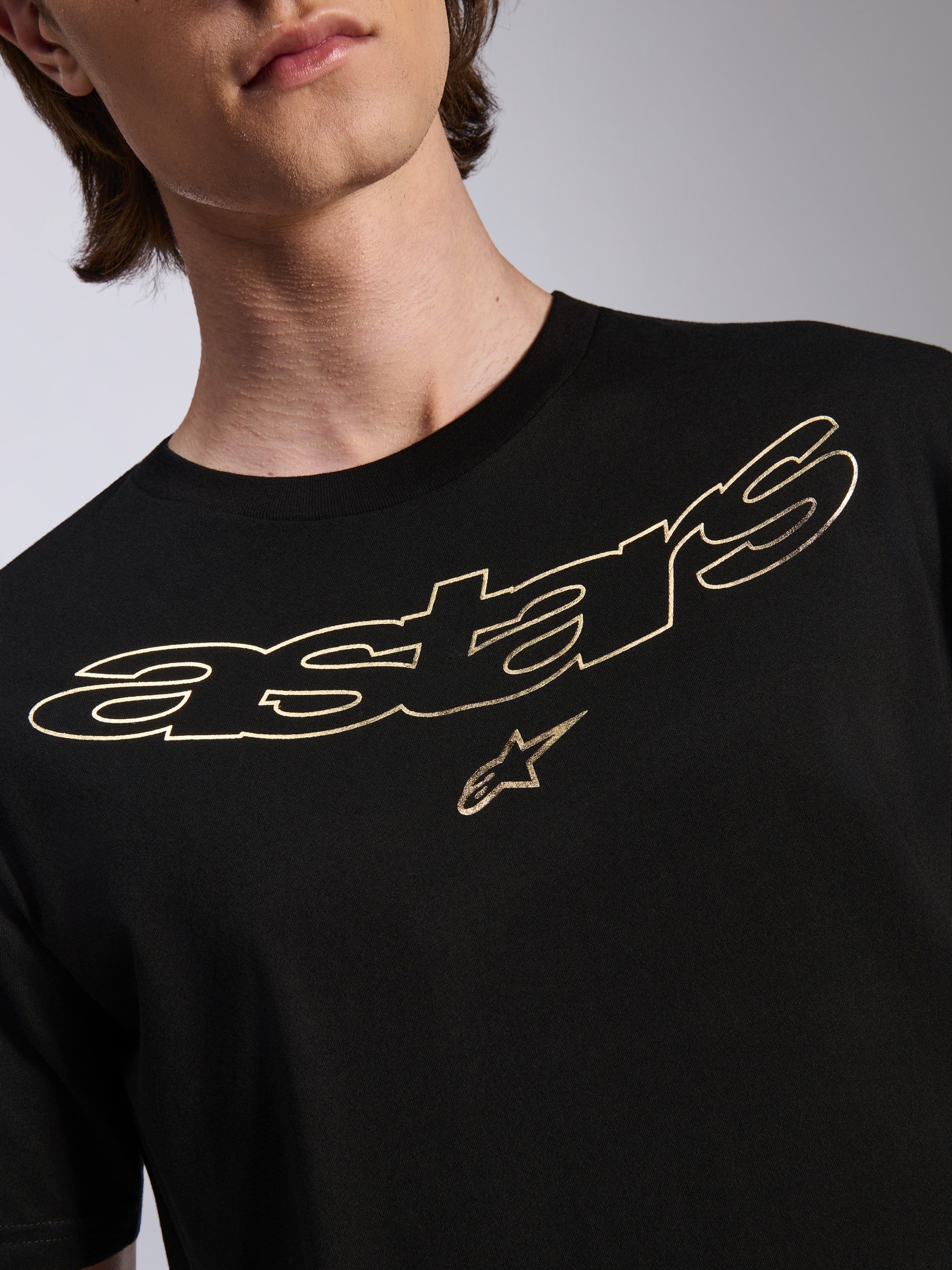 Alpinestars Luxo CSF Tee, camiseta de manga corta, negra con logotipo de Astars y gráfico de estrella perfilados en dorado, ropa urbana casual de automovilismo