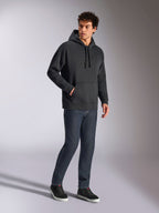 Alpinestars Emergent Oversized Hoodie, black casual streetwear, tonal 3D embroidered Astars logo on chest, kangaroo pocket, oversized fit, worn by male model with dark blue denim jeans and black sneakers