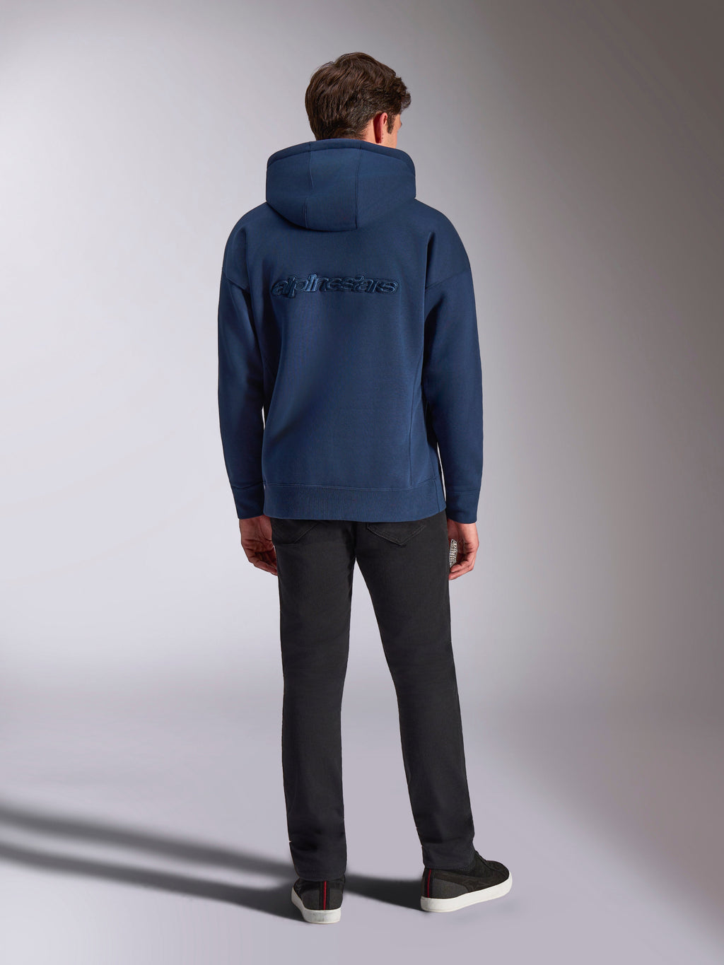Alpinestars Emergent Oversized Hoodie, casual streetwear, navy blue, tonal Alpinestars wordmark embroidered on the back, oversized fit with hood, paired with black pants, back view