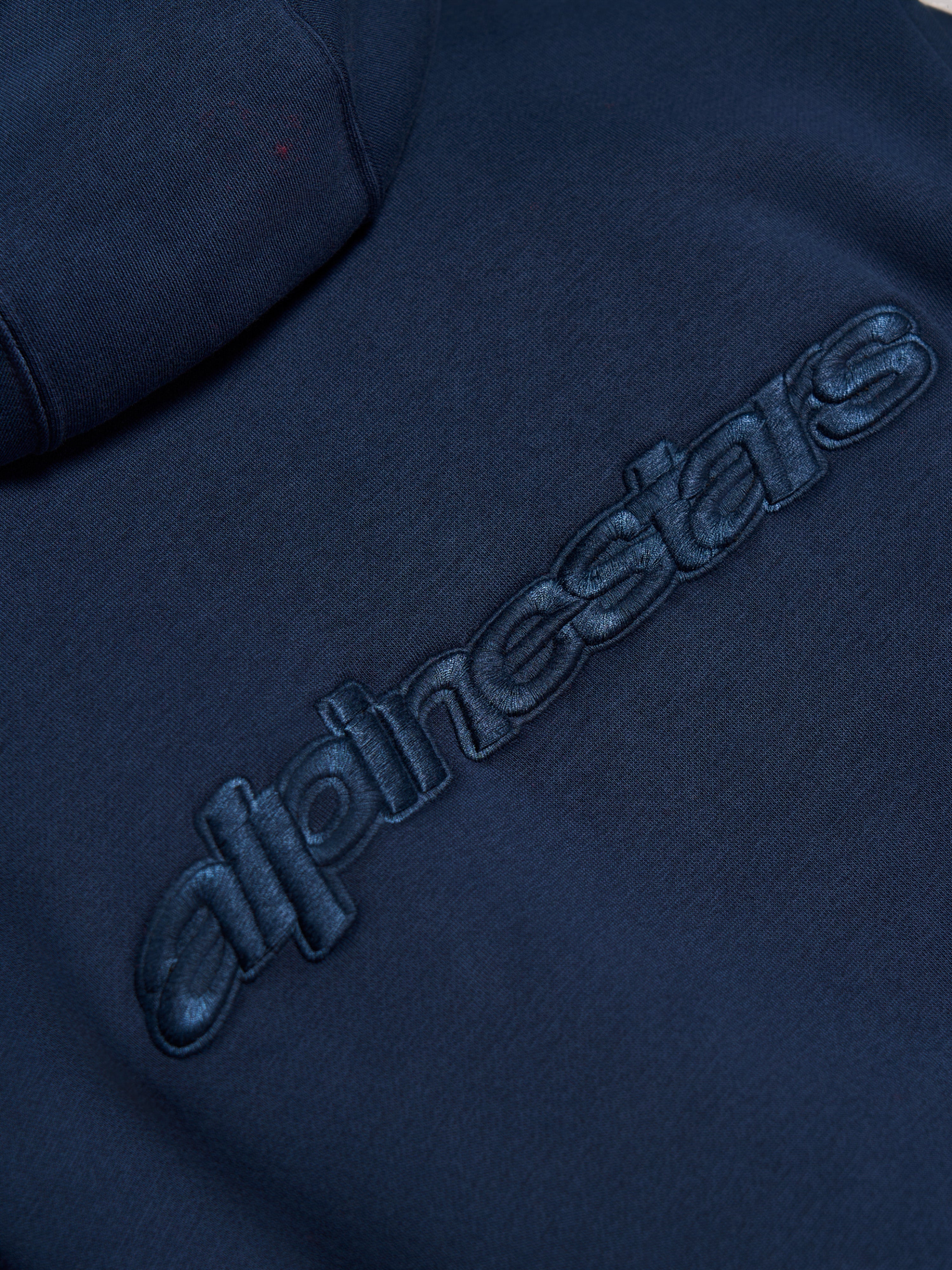 Alpinestars Emergent Oversized Hoodie, Navy Blue, close-up detail of tonal 3D embroidered Alpinestars word logo on back, premium fleece texture