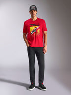 Alpinestars Noka CSF Tee, Short Sleeve T-Shirt, Red, featuring a large front Astars logo with yellow and black MX gradation, worn with black pants and a black cap, Casual Motorsport Streetwear