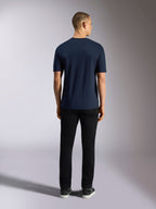 Alpinestars Noka CSF Tee, Short Sleeve T-Shirt, Navy Blue, rear view of a man wearing the t-shirt paired with black pants and sneakers, casual motorsport streetwear