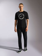 Alpinestars MX CSF Tee, Short Sleeve T-Shirt, Black, White circular Alpinestars Motocross graphic, worn by model with black pants and sneakers, casual motorsport streetwear