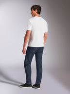 Alpinestars Abus CSF Tee, Short Sleeve T-Shirt, White, back view on model wearing dark blue jeans and black sneakers, casual motorsport-inspired design