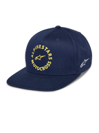 Gorra Alpinestars MX Snapback, azul marino, visera plana con corona estructurada, gráfico frontal de Alpinestars Motocross bordado en amarillo, logo Astars blanco en el lateral, tejido de sarga de algodón, accesorio casual de motorsport