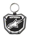 Alpinestars Plate Keyfob, llavero moldeado en 3D, negro y blanco, con gráfico de placa Astars MX, logo y texto en blanco, anillo de metal plateado, accesorio inspirado en el motorsport