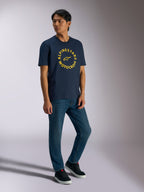 Alpinestars MX CSF Tee, Short Sleeve T-Shirt, Navy, Yellow Alpinestars Motocross circular graphic, worn by model with blue jeans and black sneakers, Casual Motorsport Streetwear