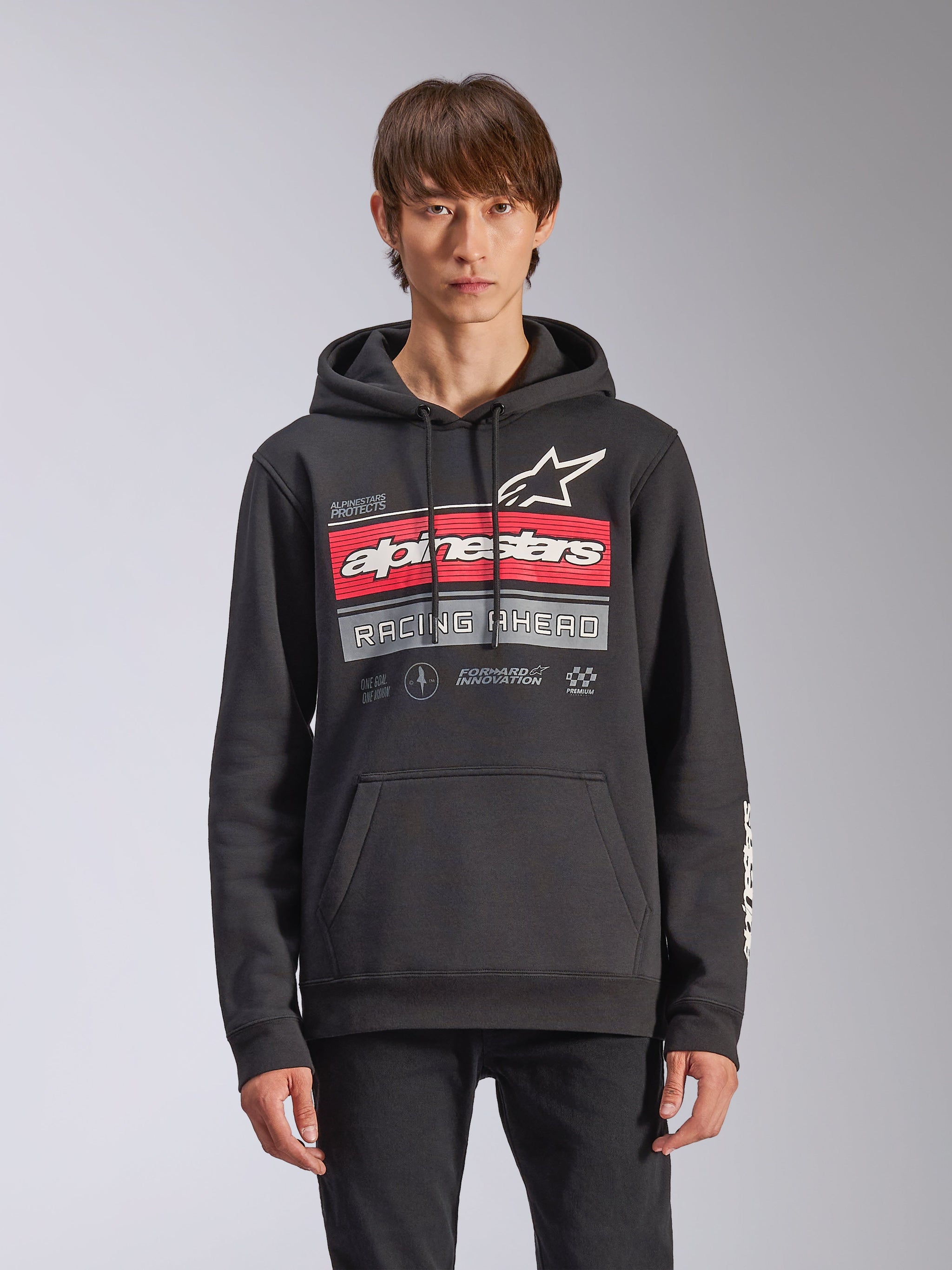 Alpinestars Harken Hoodie, sudadera de forro polar en color negro con un gráfico degradado en rojo y gris, el logotipo de Alpinestars y el texto 'Racing Ahead', bolsillo canguro, capucha con cordón y logotipos en la manga, diseño casual inspirado en el automovilismo