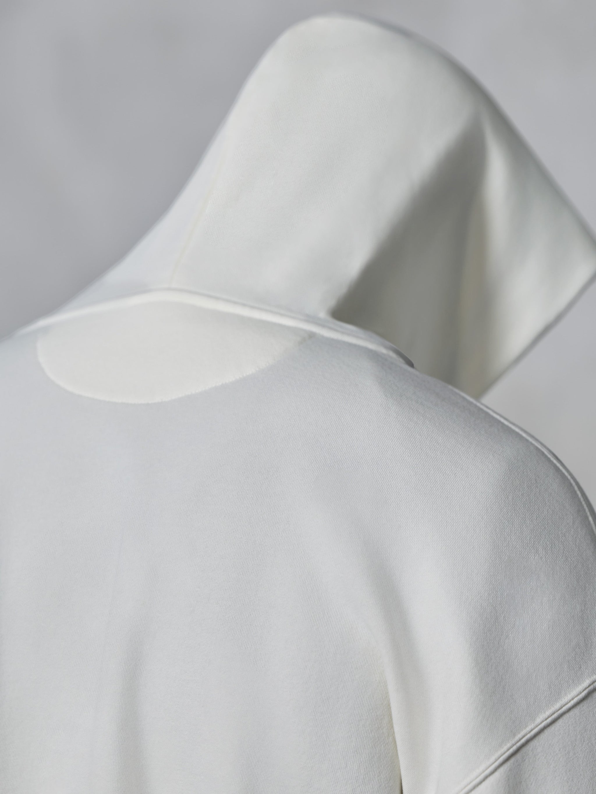 Alpinestars Essentials Ageless Zip Hoodie, Off White, close-up back view of the hood and shoulders, soft compact fleece fabric, minimalist design for casual everyday wear.