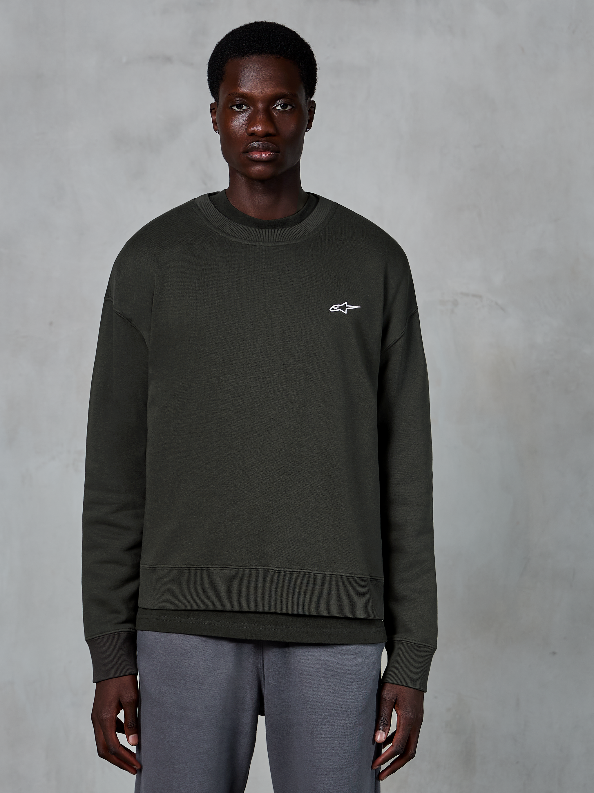 Alpinestars Essentials Ageless Crew, sudadera de cuello redondo, color Off Black, con un pequeño logotipo blanco de Alpinestars en el pecho, forro polar compacto de primera calidad, estilo casual de ropa urbana de automovilismo