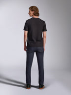 Alpinestars Global CSF Tee, Short Sleeve T-Shirt in Black, back view of male model wearing the shirt with dark denim jeans, casual motorsport-inspired streetwear