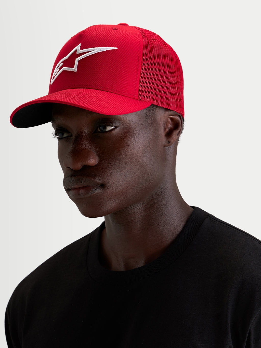 Alpinestars Ageless Snapback Hat, sportswear cap worn by a model, red and white with a prominent embroidered 3D Astar logo and curved bill, cotton twill and mesh construction