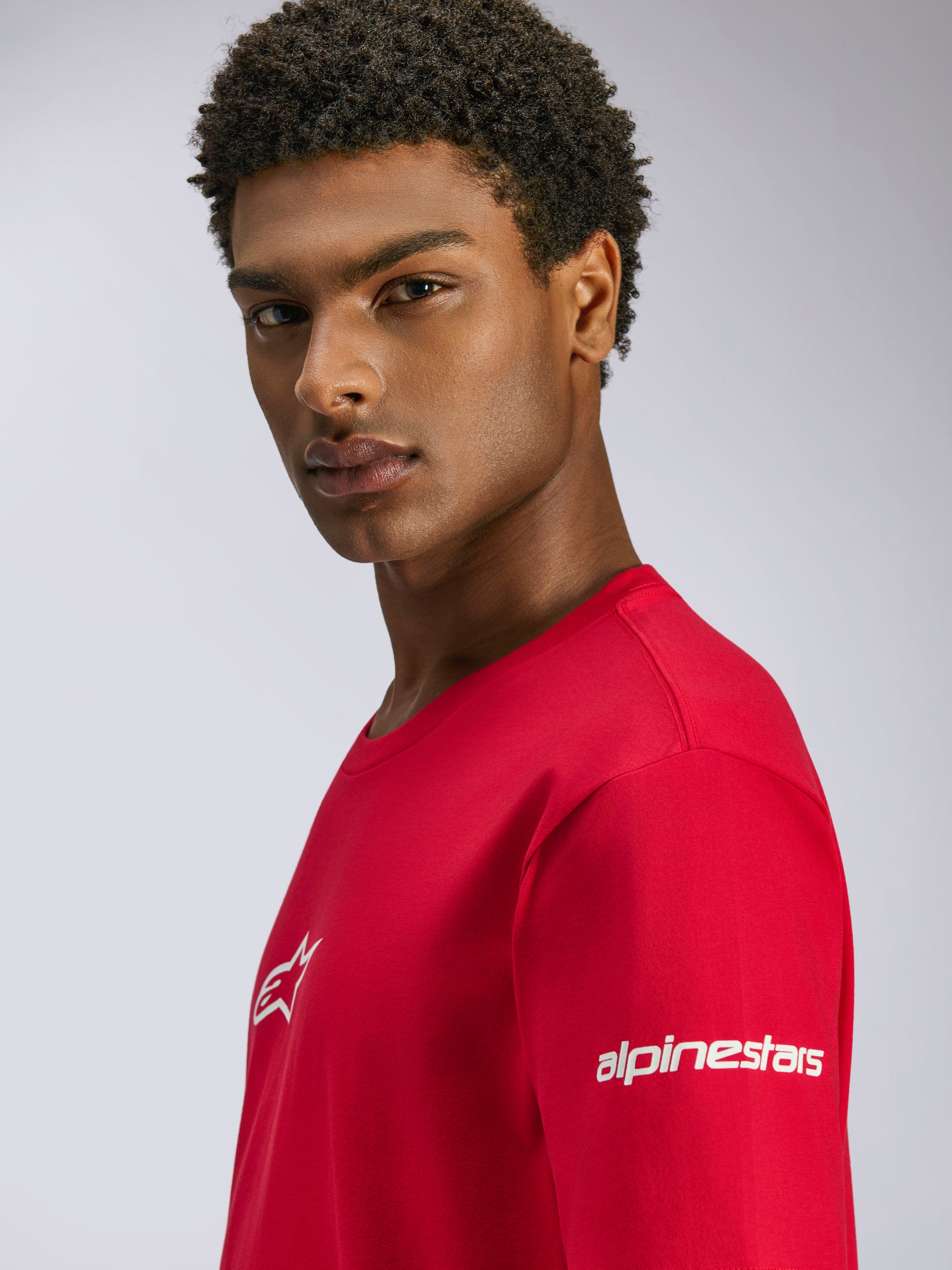 Alpinestars Frontal CSF Tee, Red Short Sleeve T-Shirt, featuring white logos on the chest and sleeve, worn by a model, casual performance motorsport streetwear
