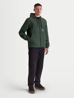 Alpinestars Speeder Resolve, chaqueta cortavientos con capucha para hombre, verde pino, construcción de poliéster ligera con forro de malla y logotipo en el pecho, ropa deportiva para uso urbano