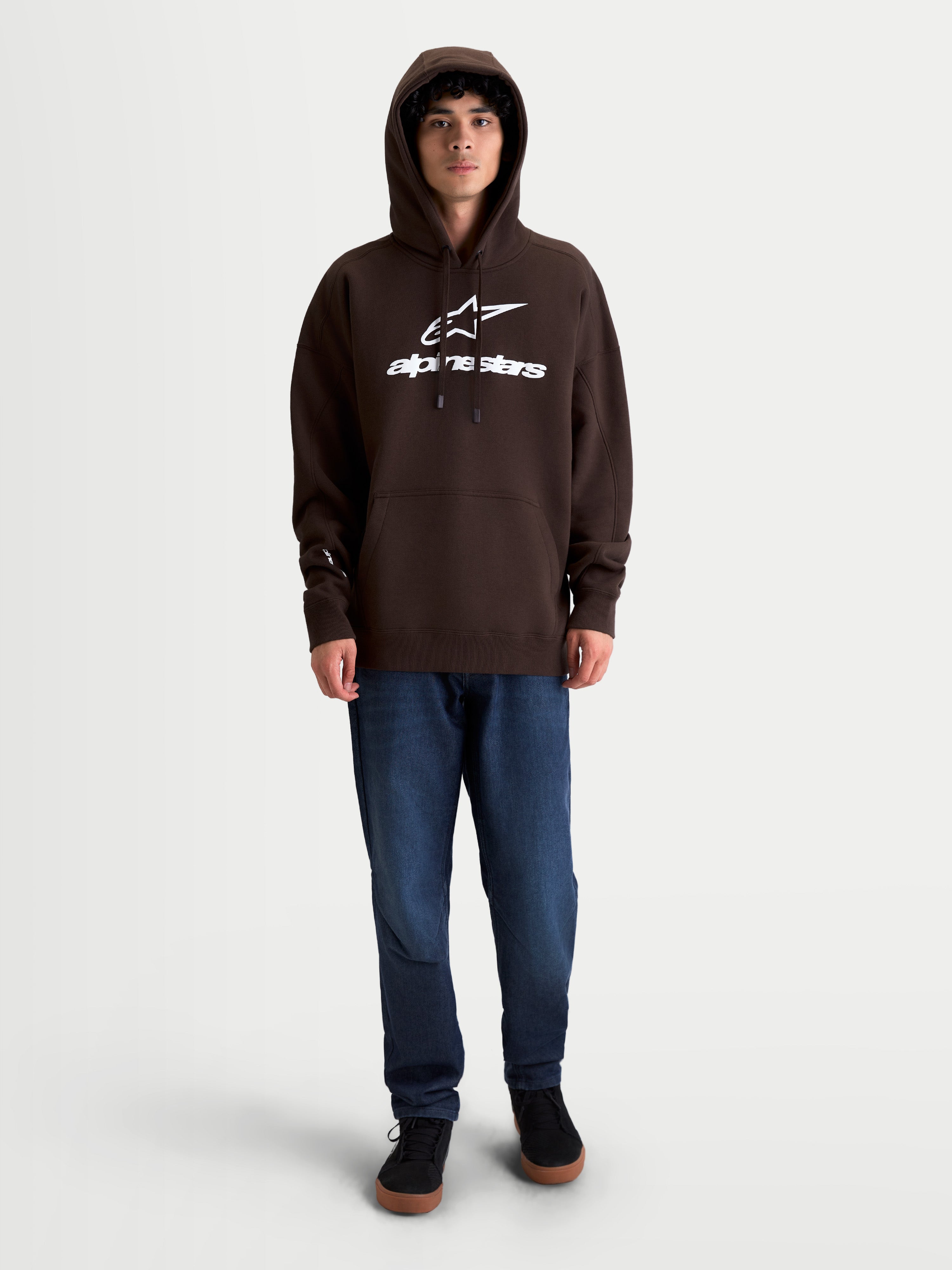 Alpinestars Prelude Oversized Hoodie, Brown Sportswear Fleece Pullover, Unisex, Cotton-Rich Material, Featuring a Relaxed Oversized Fit, White Puff-Print Chest Logo, Kangaroo Pocket, and Self-Lined Hood, Shown on Model.