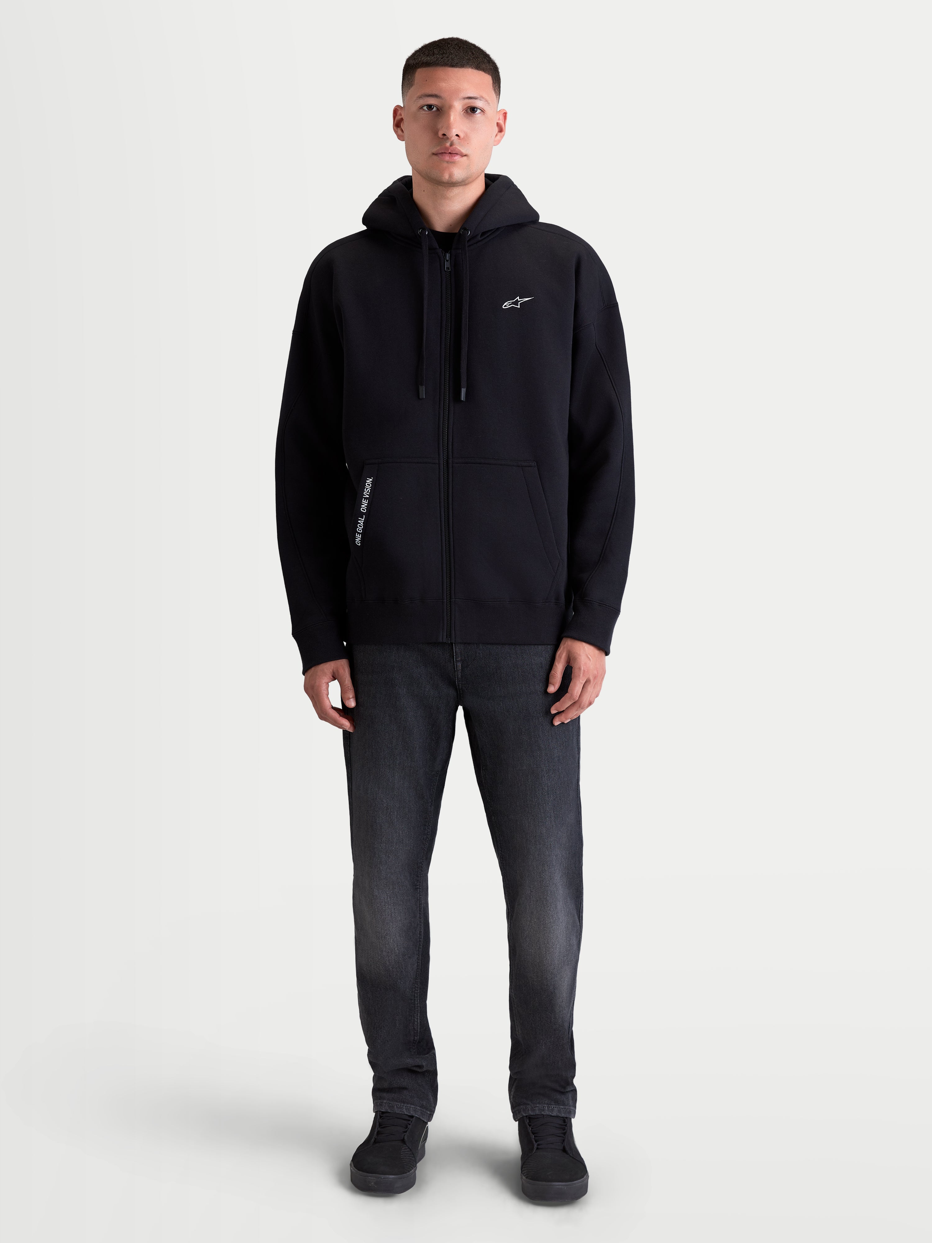 Alpinestars Sudadera con capucha Pioneer Oversized, sudadera sportswear para hombre, negra, ajuste oversize, cremallera Vislon, bolsillo canguro y logotipos bordados con el detalle 'One Goal. One Vision.'