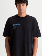 Alpinestars Chalk Oversized CSF Tee, Men's Sportswear T-Shirt, Black with Light Blue Graphics, features a relaxed oversized fit, soft-hand front Astars word logo, and side text branding, comfortable cotton/polyester blend for everyday casual wear.