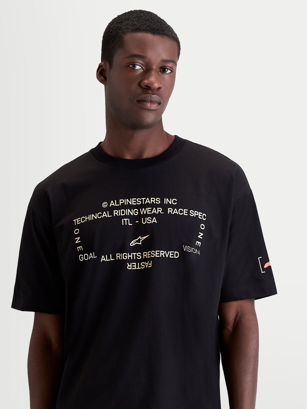 Alpinestars Infinity Oversized CSF Tee, Men's Short Sleeve Sportswear T-Shirt, Black with White Front Graphic featuring 'One Goal. One Vision.' and Orange Sleeve Branding, Oversized Fit, Casual Off-Bike Style
