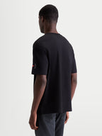 Alpinestars Infinity Oversized CSF Tee, Men's Sportswear T-Shirt, Black, oversized fit, cotton-poly blend, featuring a small Astars bracket logo on the sleeve, rear three-quarter view.