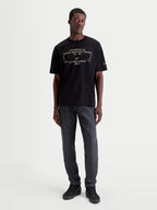 Alpinestars Infinity Oversized CSF Tee, Men's Short Sleeve Sportswear T-shirt in Black. This oversized casual tee features a technical white front graphic and a relaxed fit, crafted from a soft cotton-poly blend for everyday off-bike comfort and motorsport lifestyle style. Shown on a model.