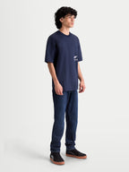 Alpinestars Institute Oversized CSF Tee, Men's Sportswear T-Shirt, Navy Blue, on-model side view showing the relaxed fit and white logo graphic on the side chest, premium cotton-poly blend material.