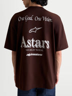 Alpinestars Camiseta Oversized Post CSF, camiseta de mangas cortas marrón, vista trasera en modelo con gráficos blancos de 'One Goal. One Vision.' y 'Astars World Wide', ajuste holgado de algodón y poliéster, ropa deportiva