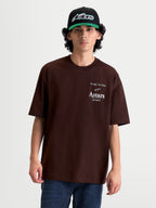 Alpinestars Camiseta Oversized Post CSF, camiseta de mangas cortas de hombre en color marrón, con gráficos del logotipo Astars y texto 'One Goal. One Vision.' en el pecho en color blanco, ajuste oversized de estilo casual