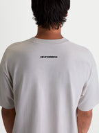 Alpinestars Mandate Oversized CSF, camiseta de mangas cortas de estilo casual, gris cemento, ajuste oversized con logotipo de Alpinestars negro en la parte superior de la espalda, vista trasera en modelo
