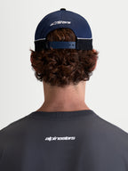 Alpinestars 500 Snapback Hat, Motorsport-inspired Sportswear Baseball Cap, Navy Blue and Black, 100% Cotton Twill construction with an adjustable snapback closure and embroidered Astars logo, rear view on model.
