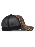 Alpinestars Thicket Realtree, gorra en camuflaje y negro con visera curva y malla trasera transpirable, vista lateral.