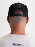 Alpinestars Hotlink Trucker Hat, Sportswear Lifestyle Cap, Unisex, Brown and Black, Rear view on-model showing adjustable snapback closure, mesh back panels for breathability, and premium branding detail.