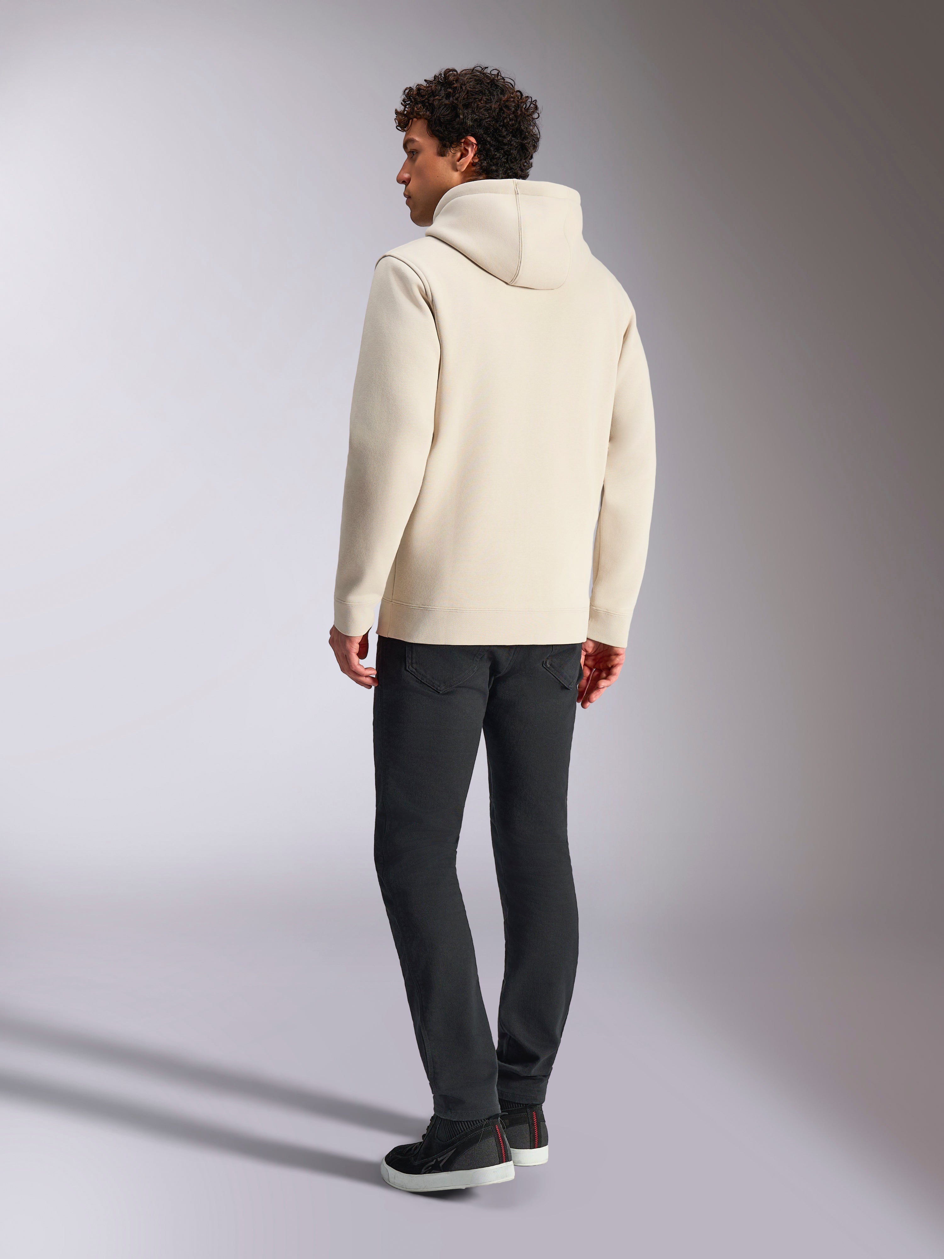 Alpinestars Always V3 Hoodie, Off White, back view of male model wearing the hoodie and black pants, casual motorsport-inspired streetwear, minimalist design with hood and ribbed hem