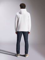 Alpinestars Blaze V3 Hoodie, white casual sportswear hoodie, back view of pullover fleece, clean design with ribbed cuffs and hem, styled with dark blue jeans and sneakers, modern motorsport-inspired lifestyle wear
