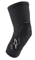 Alpinestars Paragon Lite Knee Protector, rodillera ligera negra con construcción de malla texturizada, logo blanco y líneas de diseño grises, diseño de manga tipo slip-on con etiquetas CE Nivel 1 y Polygiene, diseñado para MTB y ciclismo todoterreno
