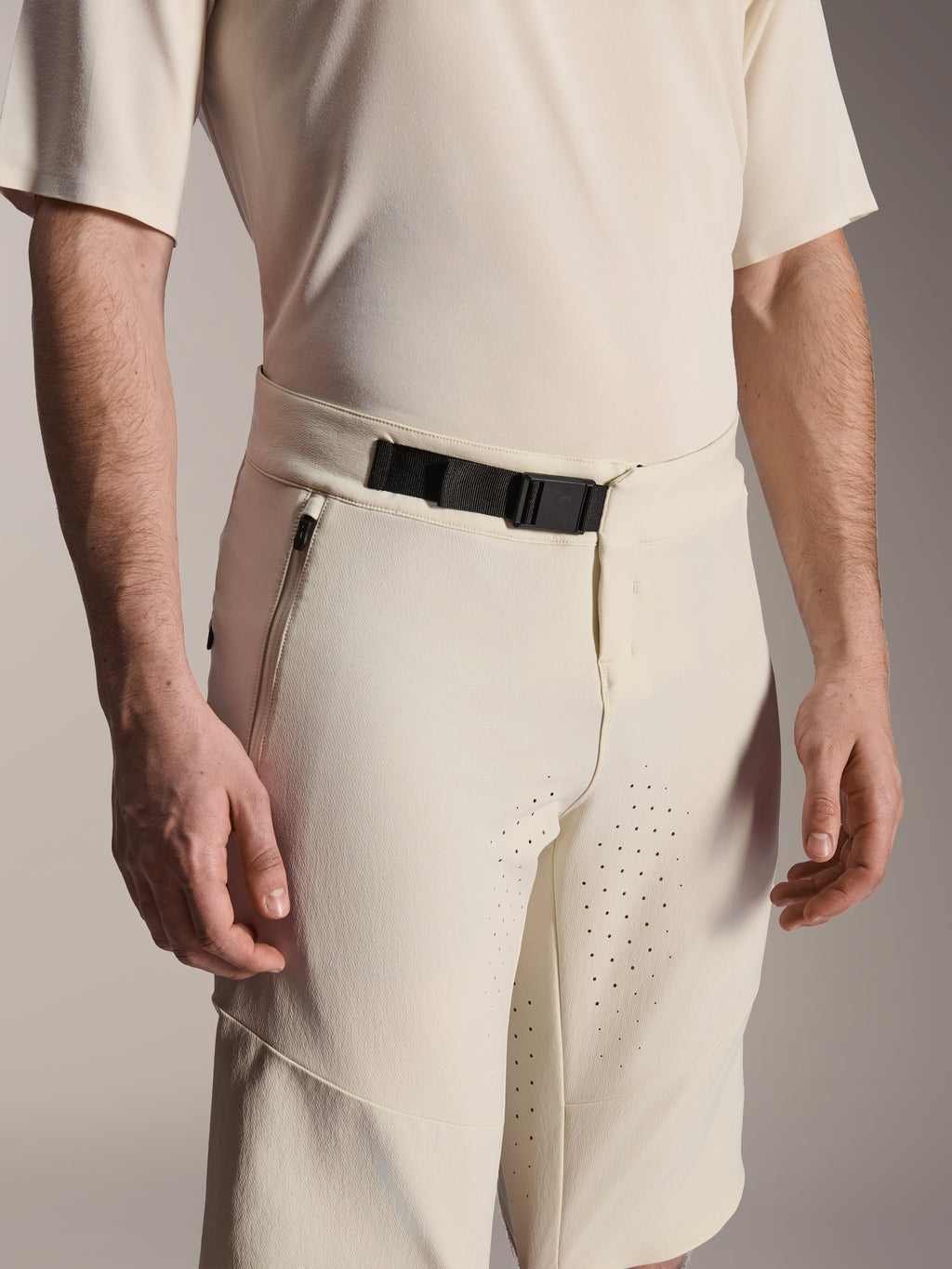 Alpinestars A-Aria Elite Shorts, shorts de mountain bike, color Ecru, vista de cerca del cierre de hebilla magnética negra, bolsillo lateral con cremallera y ventilación cortada con láser, ropa técnica de ciclismo de alto rendimiento