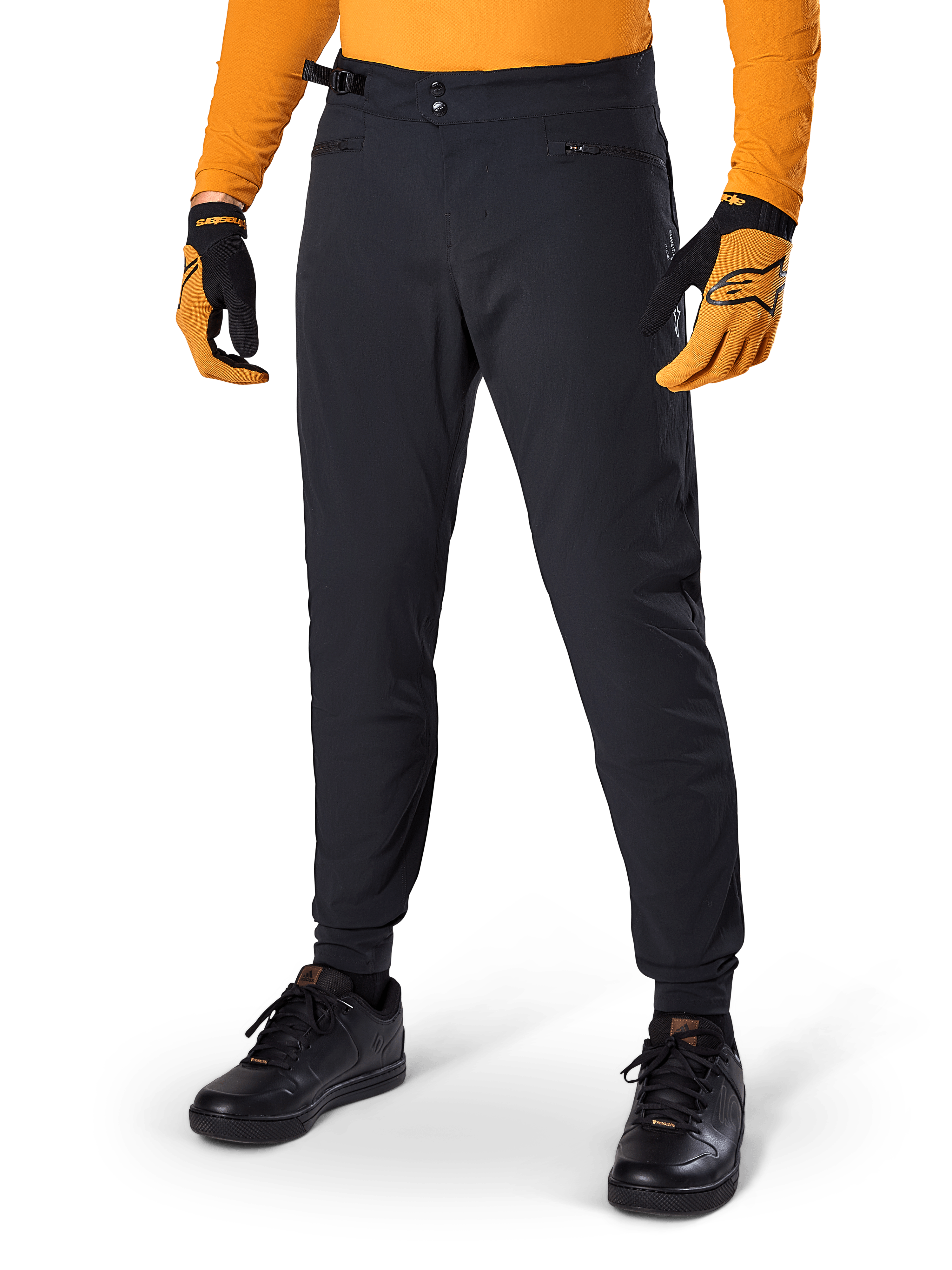 Alpinestars A-Dura Pants, Mountain Bike Pants, Black, side waist cinches and zippered pockets, worn with orange jersey and gloves, sporty regular fit for MTB riding
