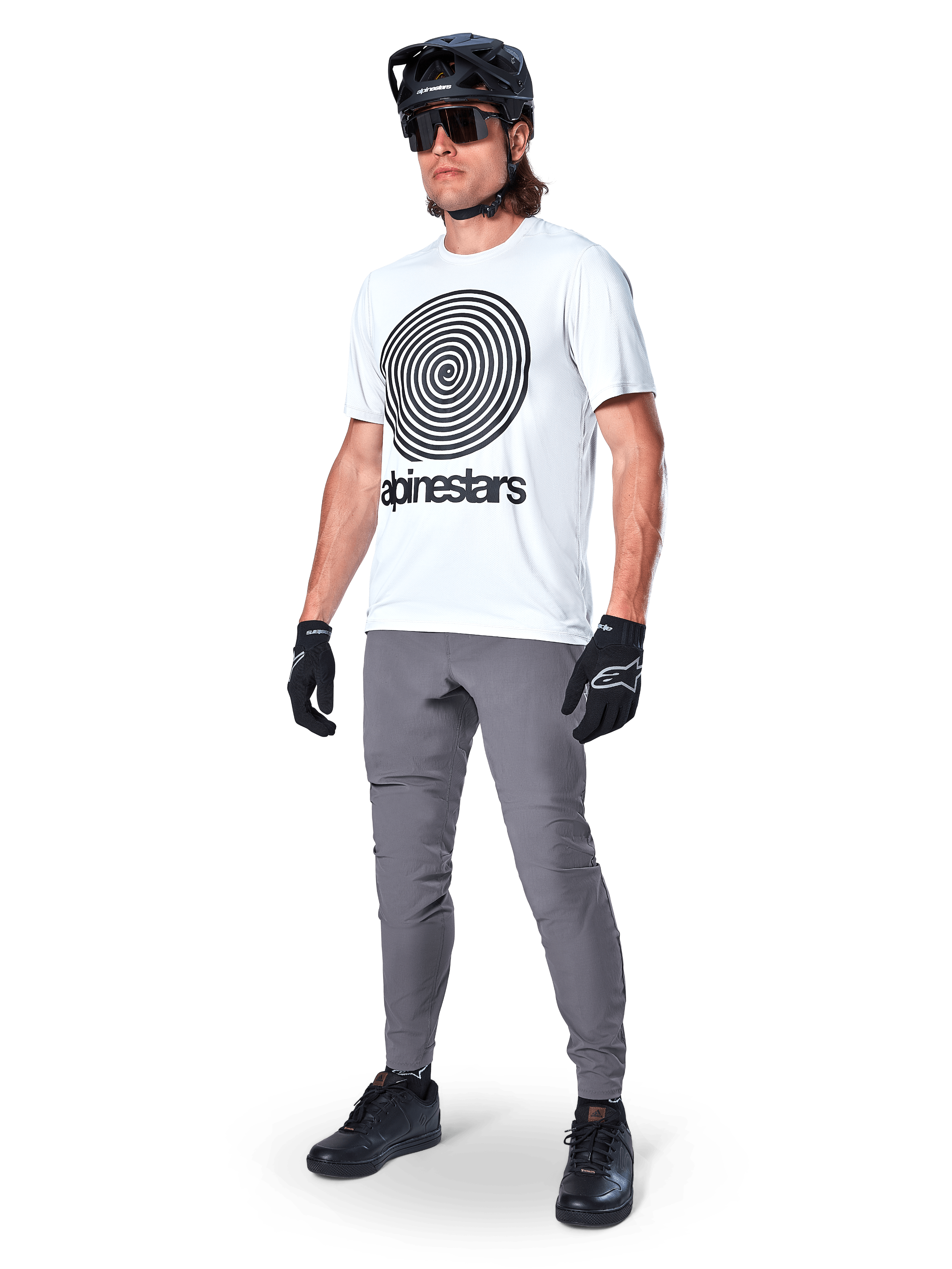 Alpinestars A-Dura Pants, MTB Pants, Dark Gray, worn with white spiral graphic t-shirt, black MTB helmet, sunglasses, and black gloves, durable 2-way stretch textile for off-road cycling