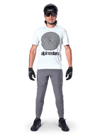 Alpinestars A-Dura Pants, MTB Cycling Pants, Dark Gray, worn with a white graphic t-shirt, black helmet, and gloves, featuring a durable 2-way stretch design and regular fit for mountain biking
