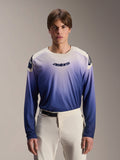 Alpinestars A-Aria Polartec Maker Elite Jersey, jersey de MTB de manga larga, color Baja Blue con degradado de blanco a azul, usado por un modelo con pantalones blancos, con logotipo azul oscuro en el pecho y perforaciones láser en las mangas, ropa de ciclismo de montaña de alto rendimiento