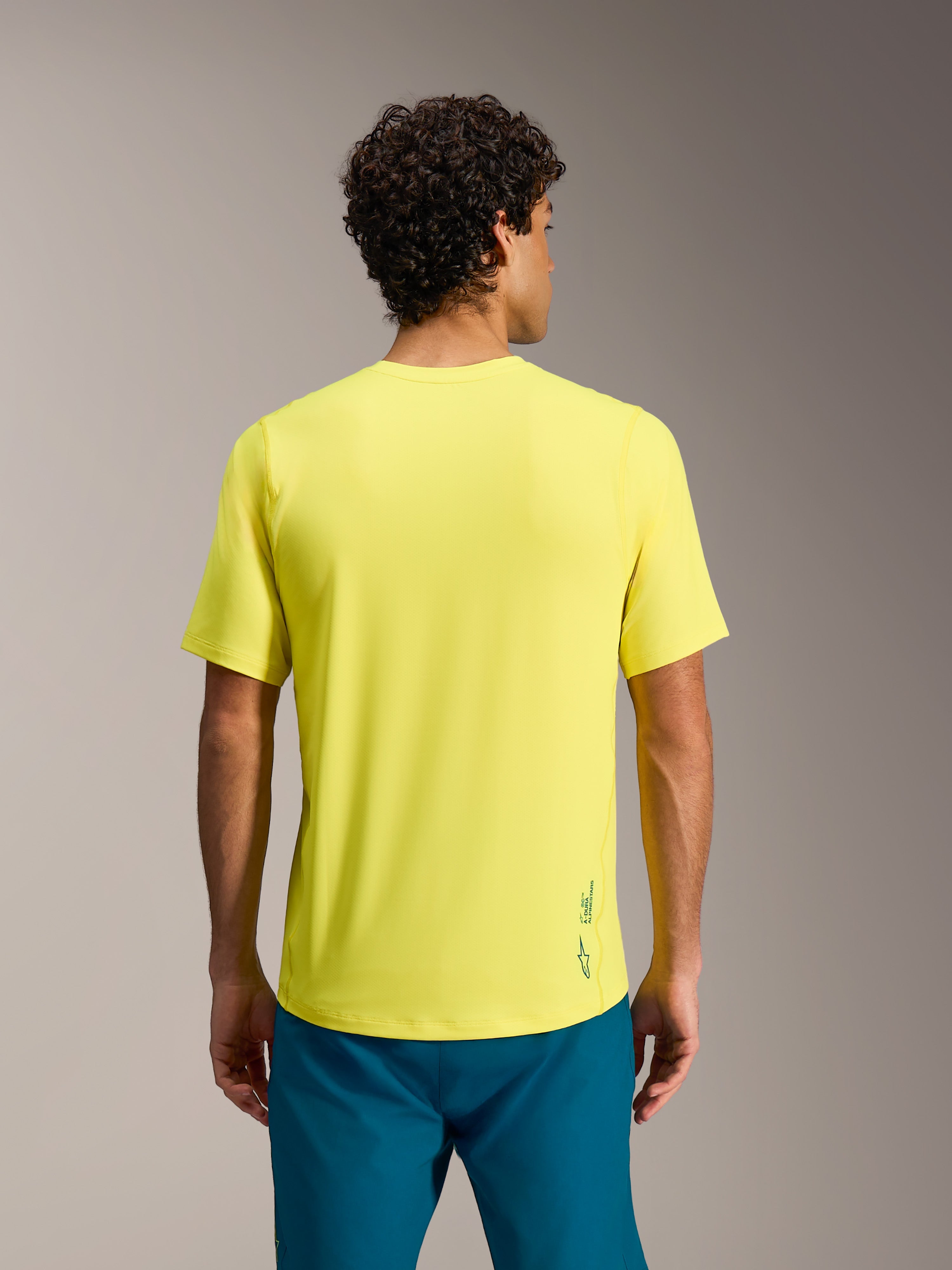 Camiseta A-Dura Ride amarilla flúor de manga corta, con logotipo Astars en la espalda y corte regular para MTB.