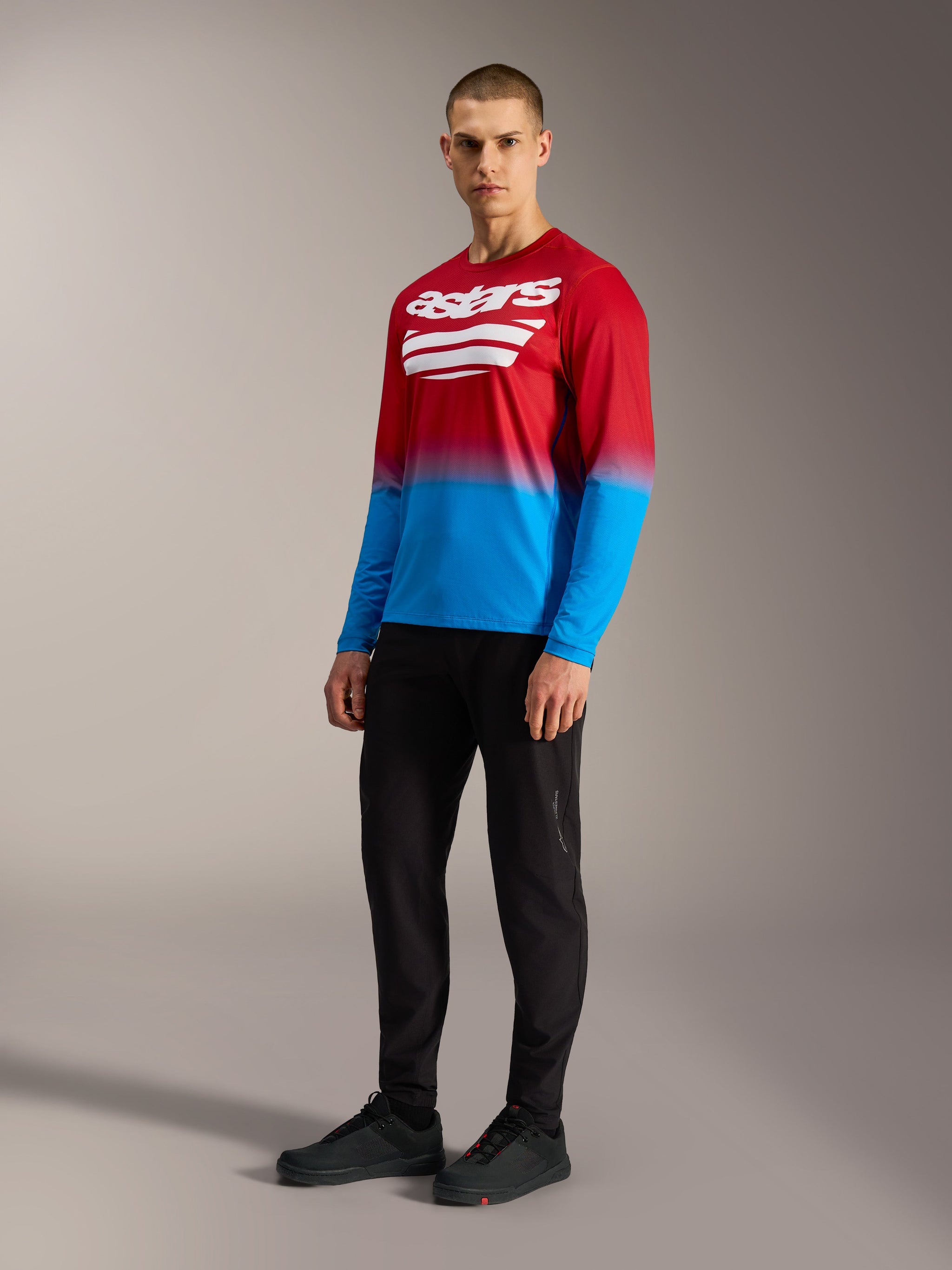 Alpinestars A-Dura ASTARS 2.0 Long Sleeve Jersey, red and blue gradient MTB top with a white chest logo.