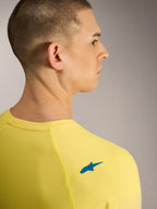 Maillot amarillo flúor A-Dura ASTARS 2.0, vista trasera con logo azul y tejido jacquard transpirable para MTB.