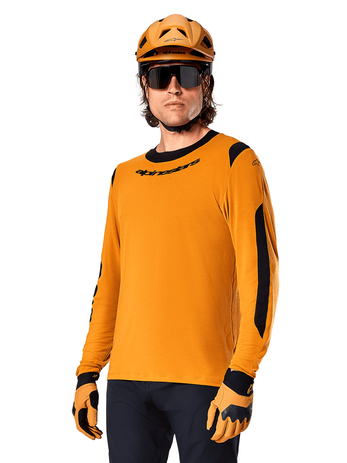 Alpinestars A-Dura Dri Wool Jersey - Long Sleeve, MTB Mountain Biking Jersey, Dark Gold and Black, featuring moisture-wicking merino wool blend and mesh panels, rider wearing matching helmet, sunglasses, and gloves