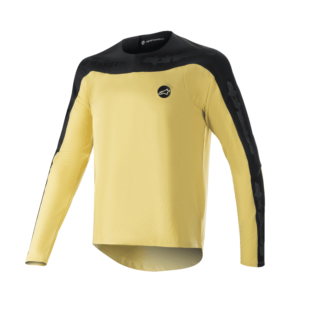 Alpinestars Drop Meta Long Sleeve Jersey, jersey de manga larga para MTB, dorado y negro, canesú de hombros y paneles en las mangas en negro, pequeño logo circular en el pecho, tejido de malla ligero y transpirable, dobladillo trasero extendido