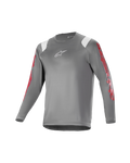 Alpinestars Youth A Supra Astar Jersey, camiseta juvenil de manga larga, gris oscuro con detalles blancos en los hombros y logotipos rojos en las mangas, logo blanco en el pecho, tejido técnico transpirable, cuello redondo, ajuste atlético de alto rendimiento para ciclismo de montaña