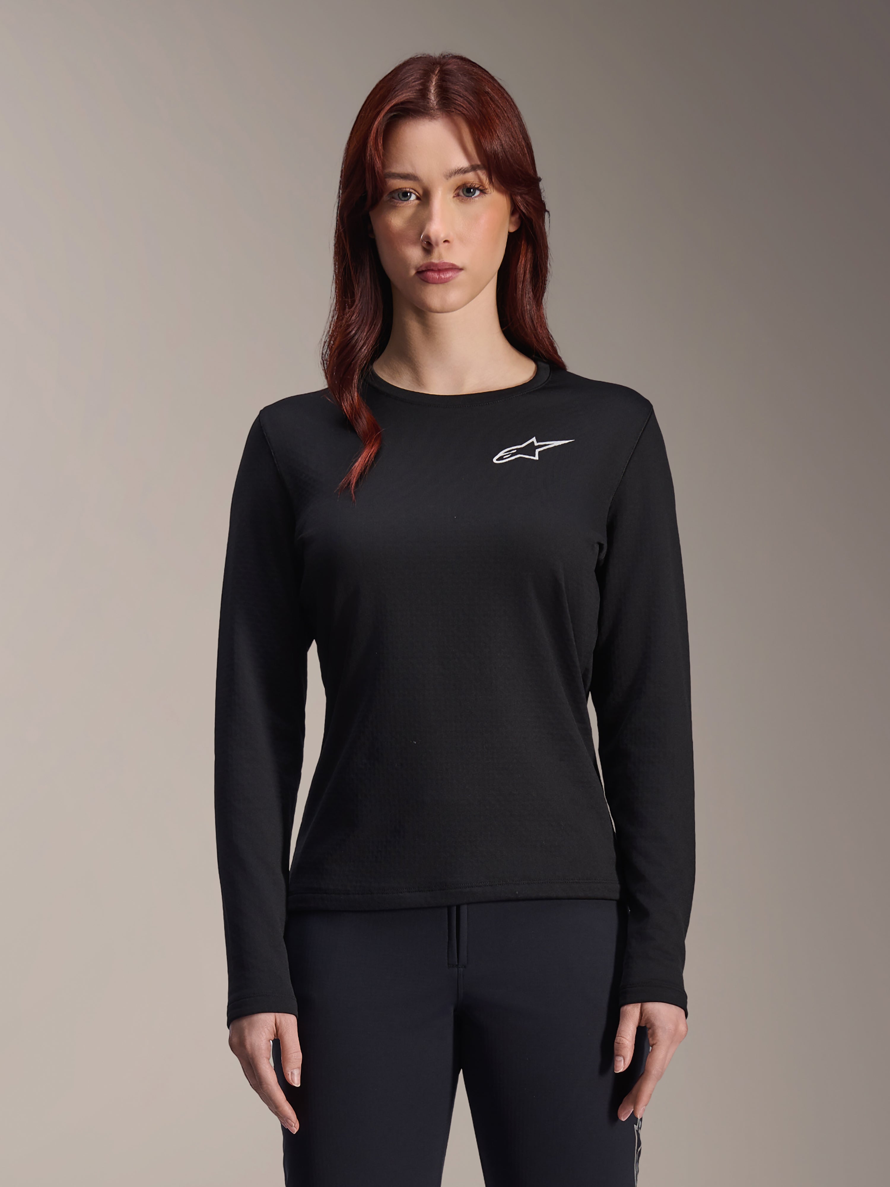 Alpinestars Stella A-Dura Thermal Jersey, Women's Long-Sleeve MTB Jersey, Black with white star logo on the chest, lightweight insulated fabric for cold weather cycling, designed for layering and trail comfort