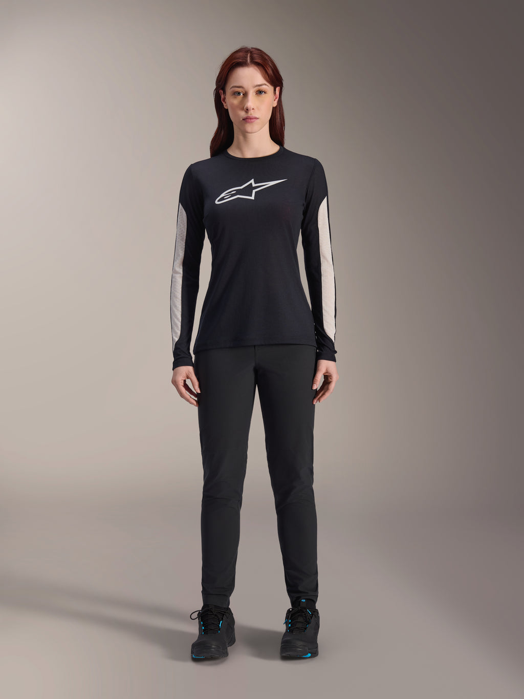 Alpinestars Women Stella A-Dura Pants, Black MTB Pants, featuring a dedicated women's fit with a streamlined design, paired with a black long-sleeve jersey and black cycling shoes, durable gear for off-road mountain biking