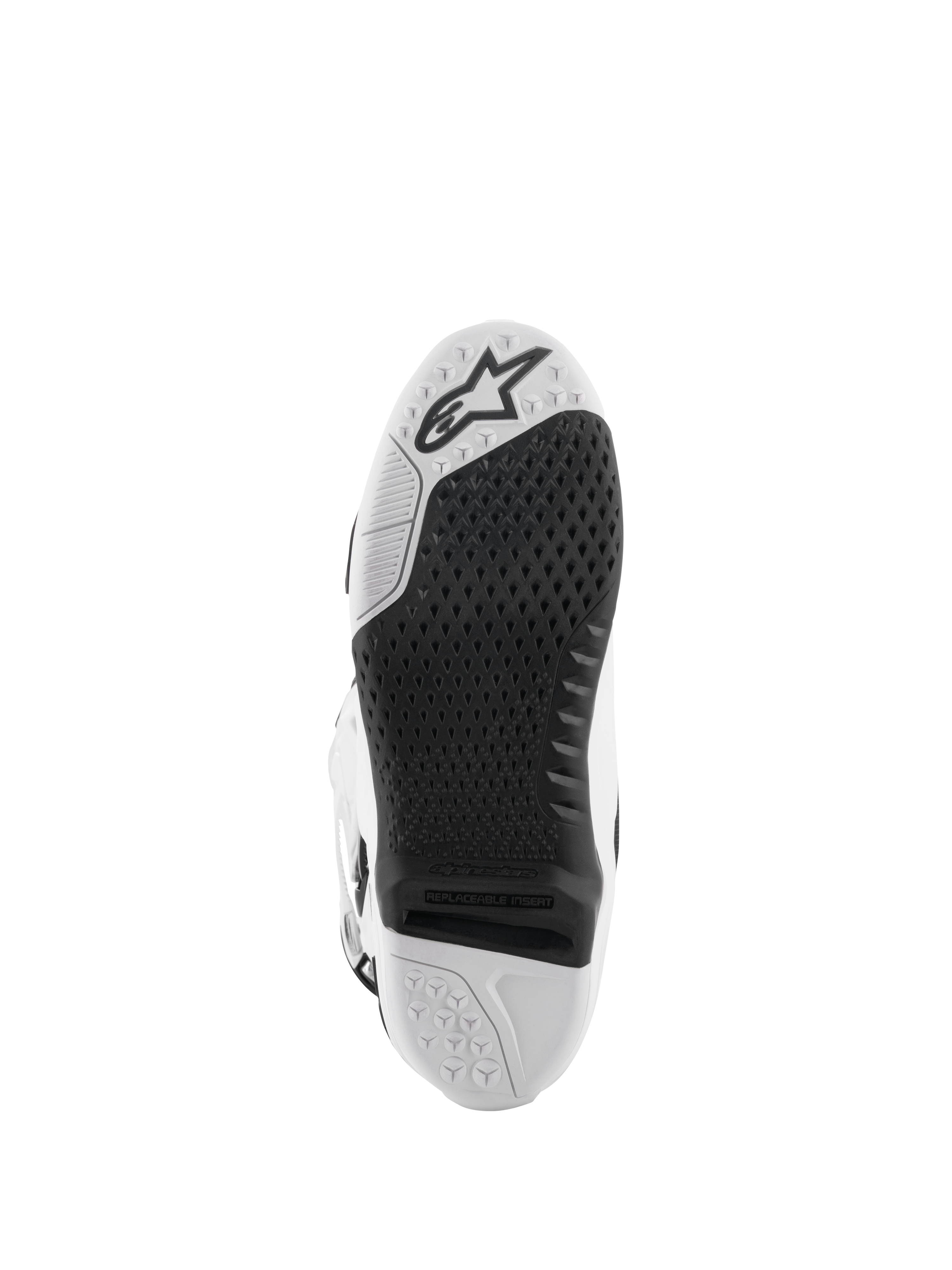 Botas Alpinestars Tech 10, botas de motocross, blancas y negras, vista inferior de la suela con un patrón de agarre texturizado, logotipo de Alpinestars e inserto central reemplazable para competición off-road.
